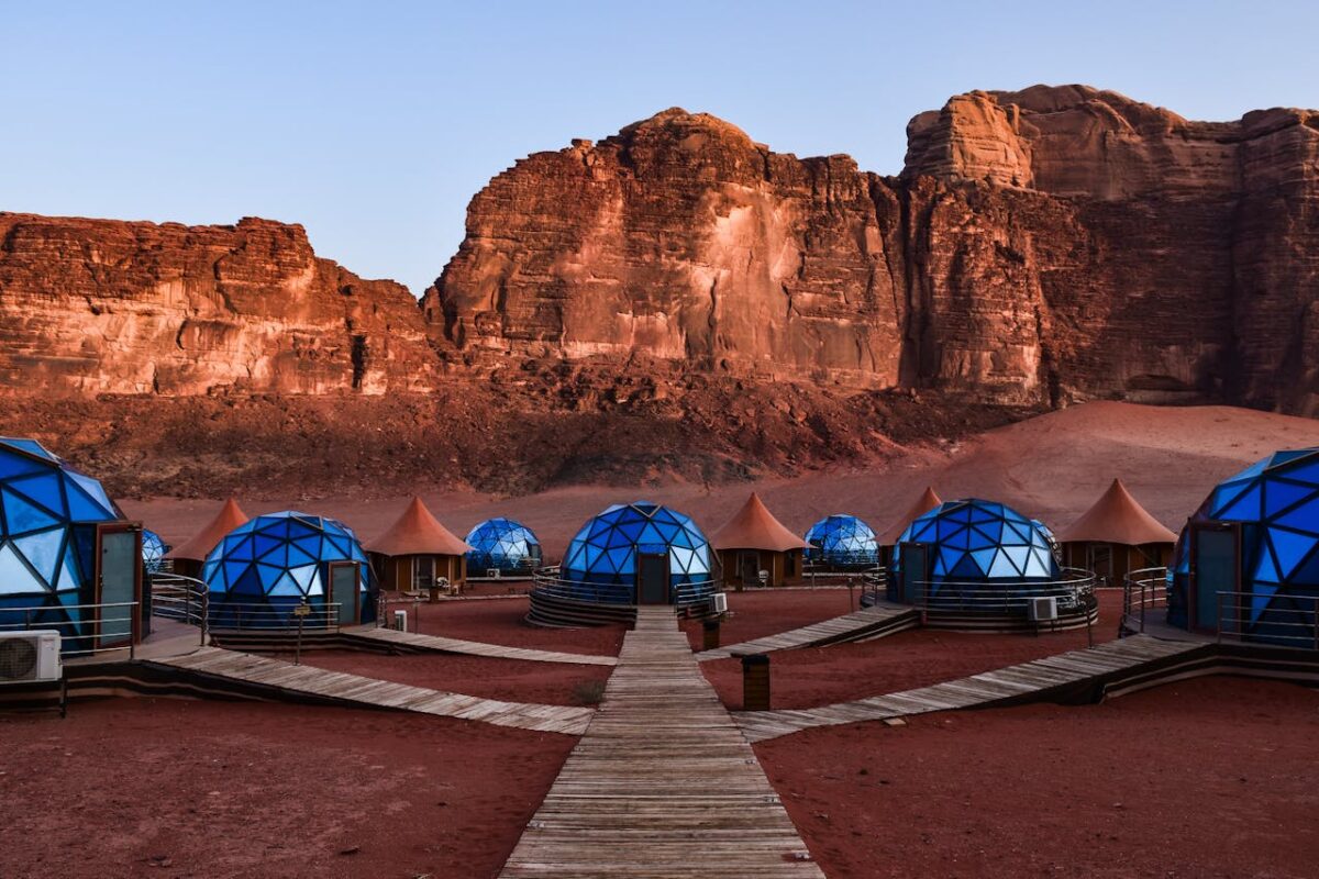 Geodesic domes at a camp with stunning desert cliffs in Wadi Rum, Jordan.