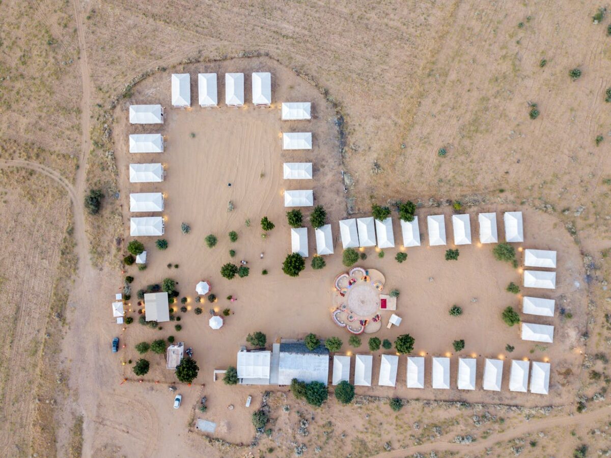 Aerial shot of a tented desert camp in Jaisalmer, India. Ideal for travel and adventure imagery.